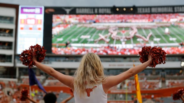 AUSTIN, TX - SEPTEMBER 03: Texas Longhorns cheerleader raises her pom pom while the Texas band performs prior to the game against the University of Louisiana Monroe Warhawks on September 03, 2022, at Darrell K Royal - Texas Memorial Stadium in Austin, TX. (Photo by Adam Davis/Icon Sportswire via Getty Images)
