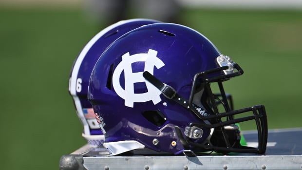 A Holy Cross Crusaders helmet on the sidelines during a game against Yale.