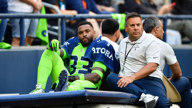 SEATTLE, WASHINGTON - SEPTEMBER 12: Jamal Adams #33 of the Seattle Seahawks is carted off the field during the second quarter against the Denver Broncos at Lumen Field on September 12, 2022 in Seattle, Washington. (Photo by Jane Gershovich/Getty Images)