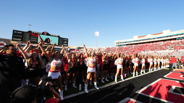 Texas Tech fans and cheerleaders on the field following the game on Saturday.