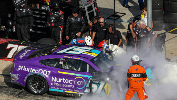 FORT WORTH, TEXAS - SEPTEMBER 25: The NASCAR Safety Crew assist Cody Ware, driver of the #51 Nurtec ODT Ford, after spinning into the pit area during the NASCAR Cup Series Auto Trader EchoPark Automotive 500 at Texas Motor Speedway on September 25, 2022 in Fort Worth, Texas. (Photo by James Gilbert/Getty Images)