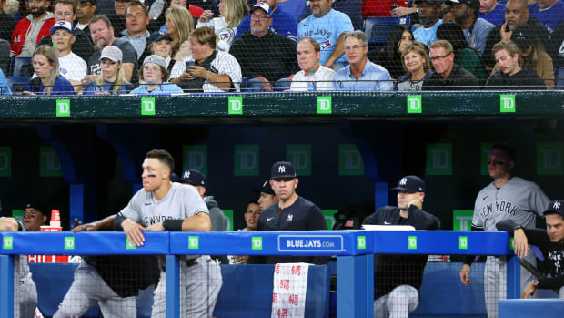 TORONTO, ON - SEPTEMBER 26:  Roger Maris Jr. (4th R, first row) talks with with Patty Judge (3rd R, first row), the mother of New York Yankees slugger Aaron Judge during a game between the Yankees and the Toronto Blue Jays in the ninth inning at Rogers Centre on September 26, 2022 in Toronto, Ontario, Canada.  (Photo by Vaughn Ridley/Getty Images)