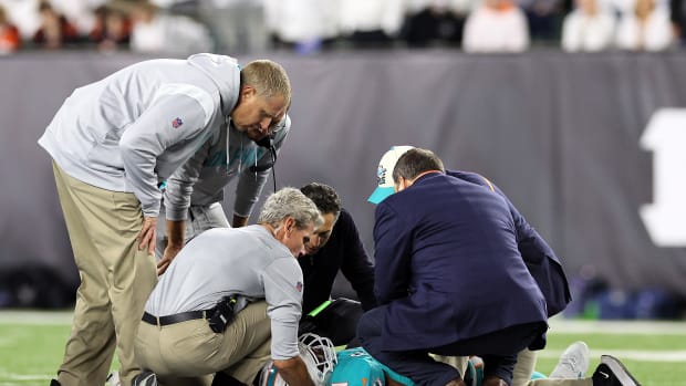 CINCINNATI, OHIO - SEPTEMBER 29:  Medical staff tend to quarterback Tua Tagovailoa #1 of the Miami Dolphins after an injury during the 2nd quarter of the game against the Cincinnati Bengals at Paycor Stadium on September 29, 2022 in Cincinnati, Ohio. (Photo by Andy Lyons/Getty Images)