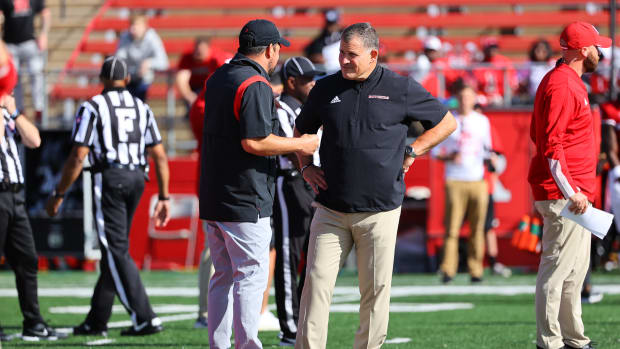 Ryan Day and Greg Schiano chat at midfield before a game.