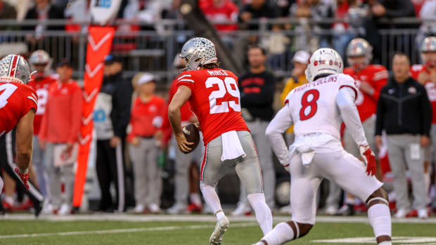Ohio State punter Jesse Mirco takes off on a fake punt against Rutgers.
