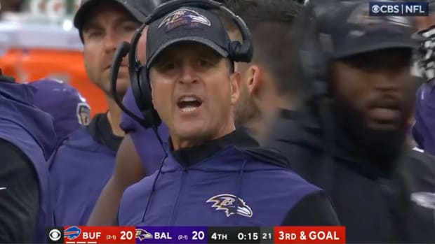 John Harbaugh and a Ravens player have to be separated on the field.