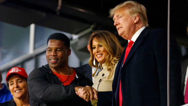ATLANTA, GEORGIA - OCTOBER 30:  Former football player and political candidate Herschel Walker interacts with former president of the United States Donald Trump prior to Game Four of the World Series between the Houston Astros and the Atlanta Braves Truist Park on October 30, 2021 in Atlanta, Georgia. (Photo by Michael Zarrilli/Getty Images)