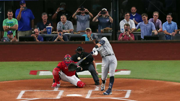 ARLINGTON, TX - OCTOBER 4: Aaron Judge #99 of the New York Yankees hits his 62nd home run of the season against the Texas Rangers during the first inning in game two of a double header at Globe Life Field on October 4, 2022 in Arlington, Texas. Judge has now set the American League record for home runs in a single season. (Photo by Ron Jenkins/Getty Images)