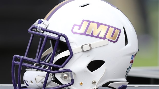 James Madison Dukes football helmet sitting on the JMU sidelines
