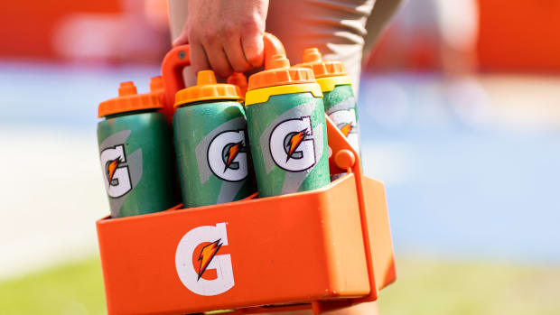 GAINESVILLE, FLORIDA - OCTOBER 09: A member of the Florida Gators training staff holds Gatorade bottles before the start of a game between the Florida Gators and the Vanderbilt Commodores at Ben Hill Griffin Stadium on October 09, 2021 in Gainesville, Florida. (Photo by James Gilbert/Getty Images)