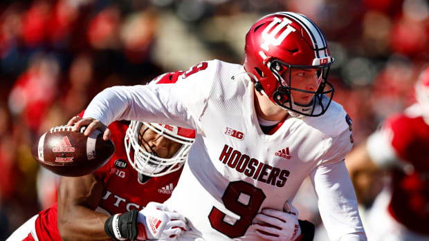 Indiana quarterback Connor Bazelak is chased by a Rutgers defender during a game.