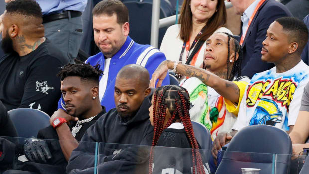 INGLEWOOD, CALIFORNIA - FEBRUARY 13: Antonio Brown, Kanye West and North West attend Super Bowl LVI between the Los Angeles Rams and the Cincinnati Bengals at SoFi Stadium on February 13, 2022 in Inglewood, California. (Photo by Steph Chambers/Getty Images)