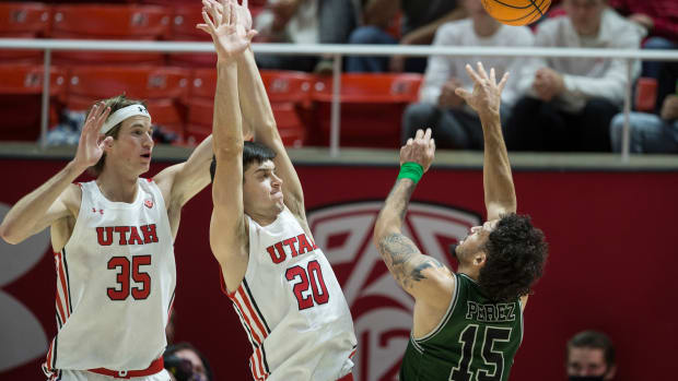 Manhattan's Jose Perez goes up for a shot over two Utah players.