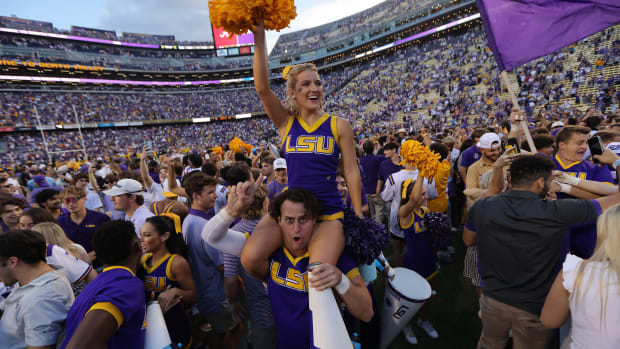 Fans celebrate on the field after the LSU Tigers' win (Photo by Jonathan Bachman/Getty Images)