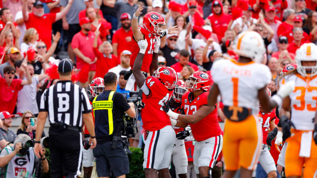 ATHENS, GEORGIA - NOVEMBER 05: Stetson Bennett #13 of the Georgia Bulldogs celebrates with teammates after scoring a touchdown against the Tennessee Volunteers during the first quarter at Sanford Stadium on November 05, 2022 in Athens, Georgia. (Photo by Todd Kirkland/Getty Images)