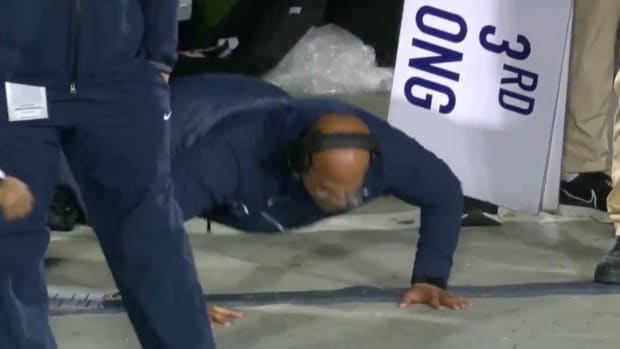 James Franklin doing push-ups during the game.