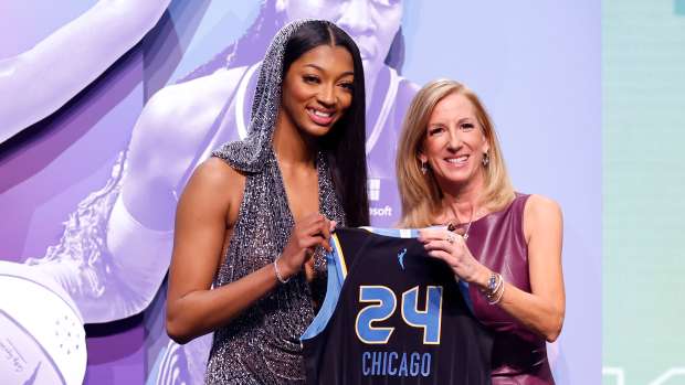 Angel Reese poses with WNBA commissioner Cathy Engelbert after being drafted.