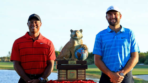 NASSAU, BAHAMAS - DECEMBER 03: Scottie Scheffler of the United States and tournament host Tiger Woods pose with the trophy after winning the final round of the Hero World Challenge at Albany Golf Course on December 03, 2023 in Nassau, . (Photo by Mike Ehrmann/Getty Images,)
