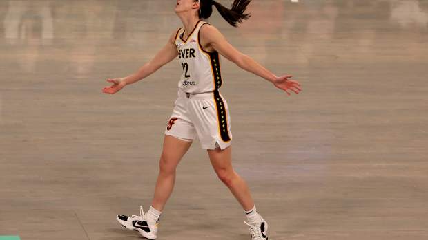 Caitlin Clark waves her arms on the court.