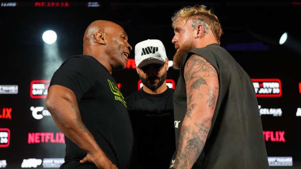 ARLINGTON, TEXAS - MAY 16: (L-R) Mike Tyson, Nakisa Bidarian and Jake Paul pose onstage during the Jake Paul vs. Mike Tyson Boxing match Arlington press conference at Texas Live! on May 16, 2024 in Arlington, Texas.  (Photo by Cooper Neill/Getty Images for Netflix)
