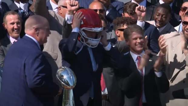 Joe Biden wears a Chiefs helmet.