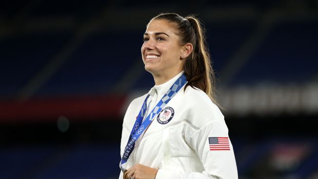 TOKYO, JAPAN - AUGUST 06: Alex Morgan of Team USA poses with her Bronze medal after the Gold Medal Match Women's Football match between Canada and Sweden at International Stadium Yokohama on August 06, 2021 in Yokohama, Kanagawa, Japan. (Photo by Naomi Baker/Getty Images)