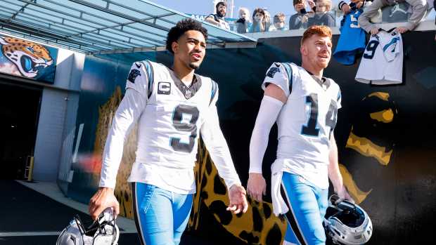 Bryce Young and Andy Dalton taking the field before a game.