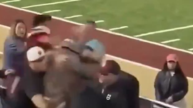 A high school football player punched another player's father in the stands.