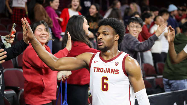 LOS ANGELES, CALIFORNIA - JANUARY 03: Bronny James #6 of the USC Trojans high-fives fans after defeating the California Golden Bears at Galen Center on January 03, 2024 in Los Angeles, California. (Photo by Meg Oliphant/Getty Images)