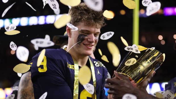 HOUSTON, TEXAS - JANUARY 08: J.J. McCarthy #9 of the Michigan Wolverines celebrates after defeating the Washington Huskies during the 2024 CFP National Championship game at NRG Stadium on January 08, 2024 in Houston, Texas. Michigan defeated Washington 34-13. (Photo by Gregory Shamus/Getty Images)