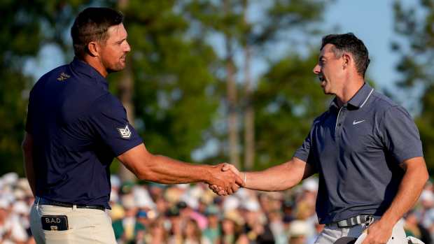 Rory McIlroy shakes hands with Bryson DeChambeau.