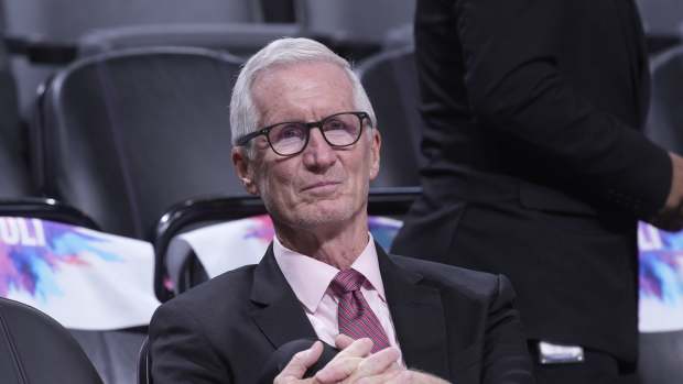 Mike Breen sits down at an NBA game.