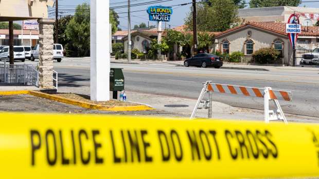 Police tape on sidewalk.
