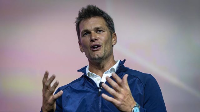 Tom Brady delivering a keynote speech.
