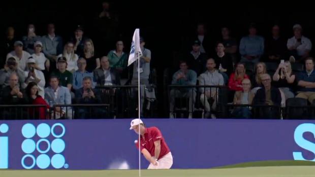 Kevin Kisner hits the flagstick.