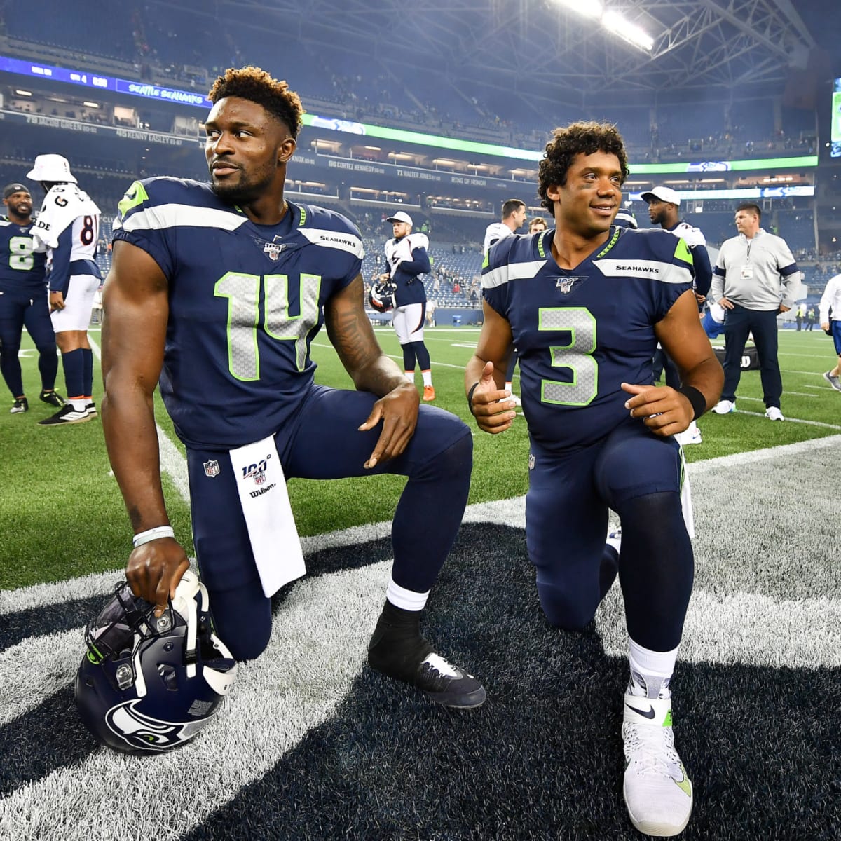 Seattle Seahawks quarterback Russell Wilson (3) greets wide receiver DK  Metcalf (14) during warmups before an NFL football game against the Tennessee  Titans, Sunday, Sept. 19, 2021, in Seattle. (AP Photo/John Froschauer