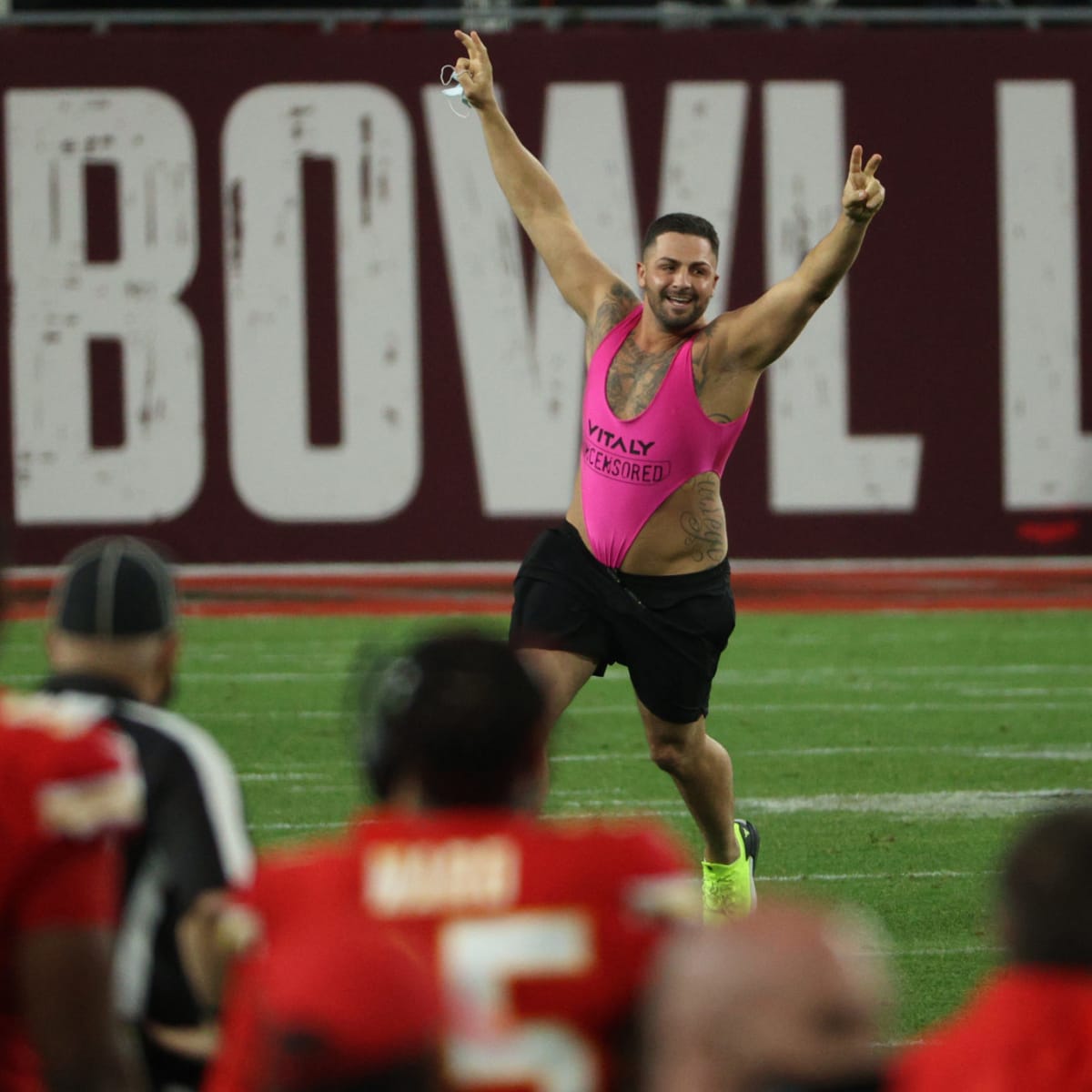 Streaker: Fan in pink one-piece runs on field during Super Bowl LV