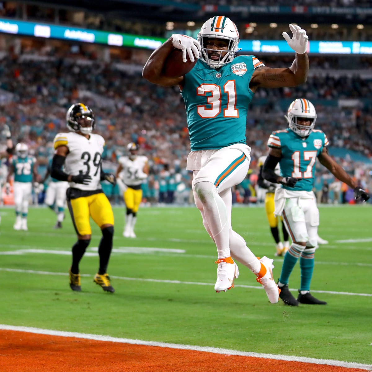 Miami Dolphins running back Raheem Mostert (31) runs with the ball