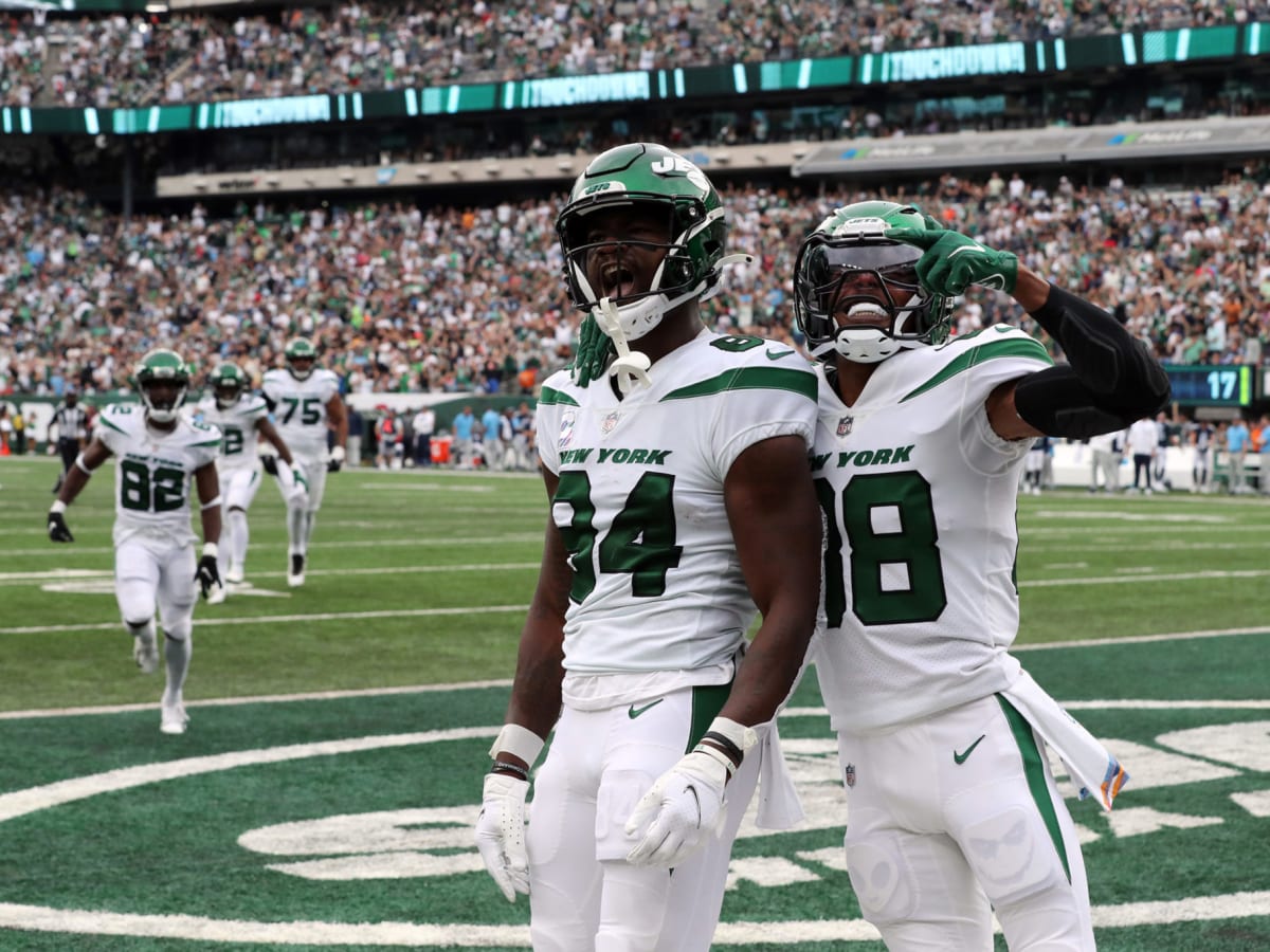 New York Jets quarterback Zach Wilson (2) and wide receiver Corey Davis  (84) celebrate after a touchdown against the Tennessee Titans during an NFL  football game, Sunday, Oct. 3, 2021, in East