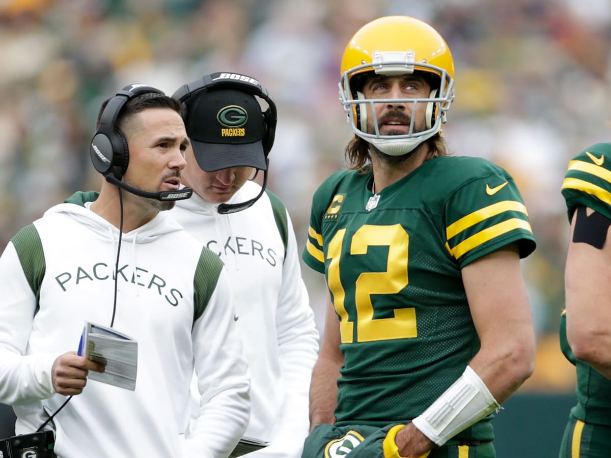 October 24, 2021: Green Bay Packers quarterback Aaron Rodgers #12 warms up  before the NFL football game between the Washington Football Team and the Green  Bay Packers at Lambeau Field in Green