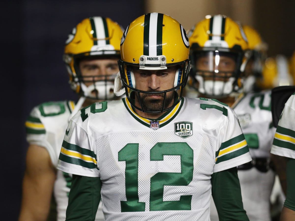 Green Bay Packers' Mike McCarthy holds a team helmet after being