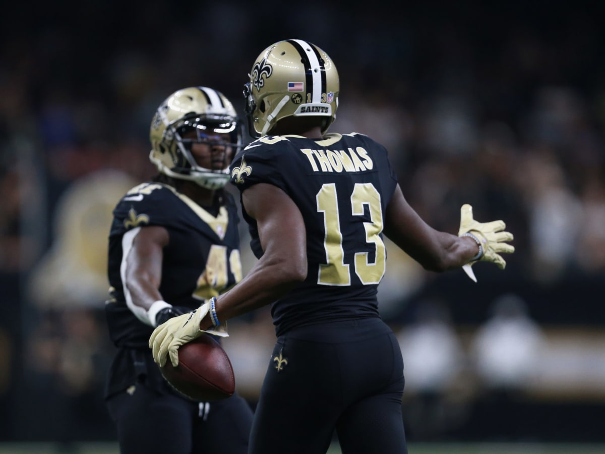 Chris Olave & Michael Thomas New Orleans Saints Unsigned Embracing in White Jerseys Photograph