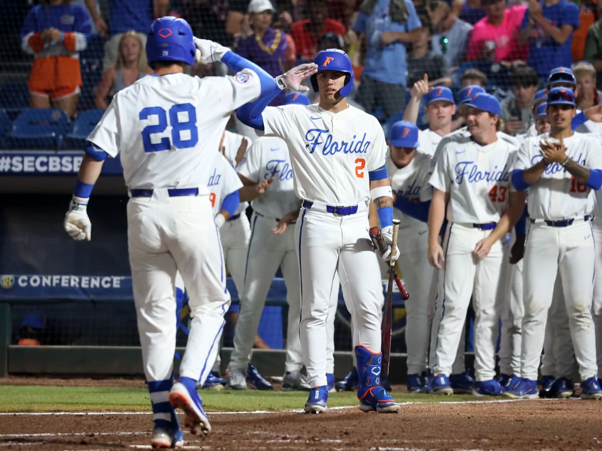 Florida infielder Josh Rivera (24) celebrates while running to