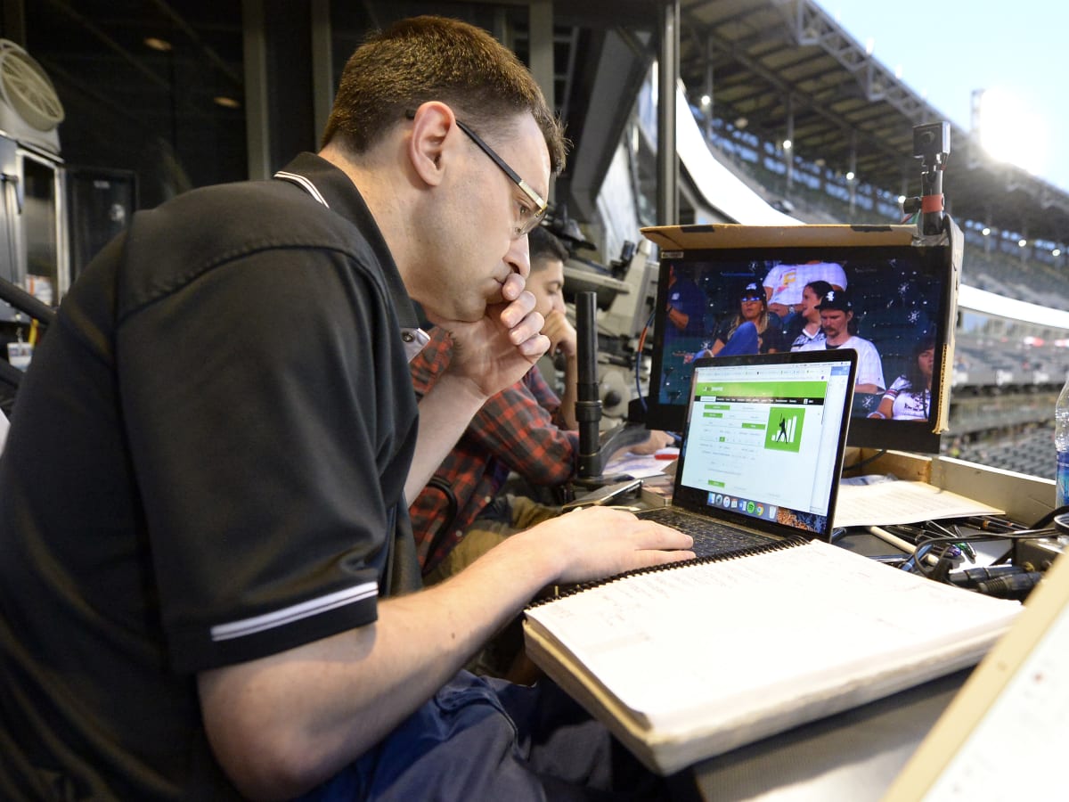 Fox Sports play-by-play announcer Jason Benetti (left) and analyst Brock  Huard in the booth prior to an NCAA college football game for the Pac-12  Conference championship between Southern California and Utah, Friday