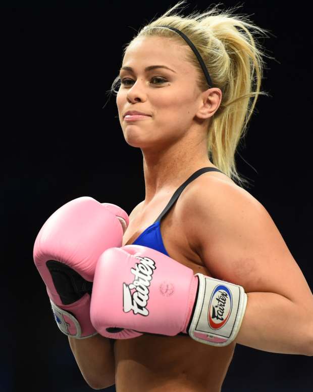 Paige VanZant in the ring with gloves.