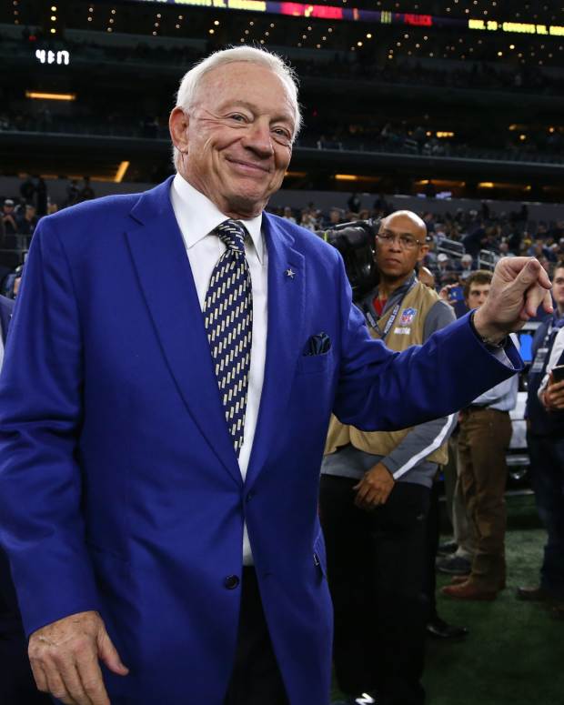 dallas cowboys owner jerry jones walks onto the field