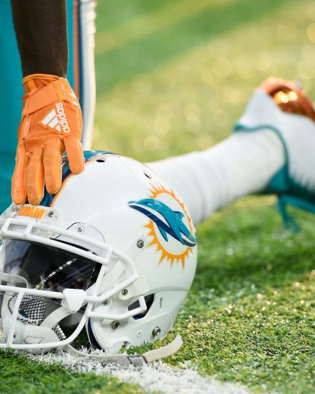 A Miami Dolphins helmet sitting on the field.