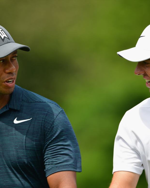 Tiger Woods and Rory McIlroy walk the course.