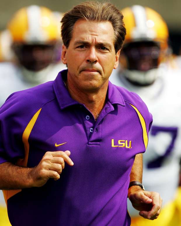 Nick Saban jogs onto the field before an LSU game.