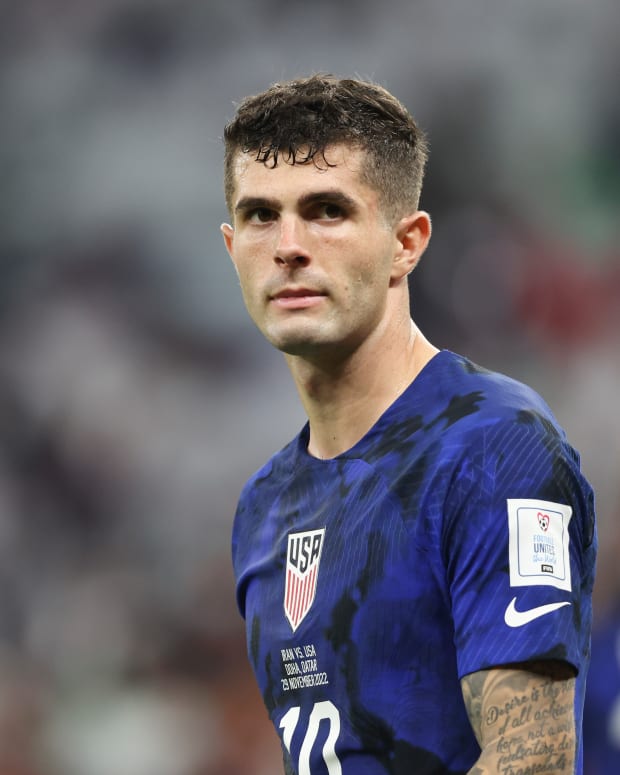 Christian Pulisic walks on the field during a game against Iran.